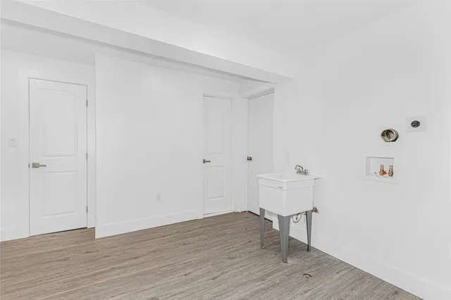 a view of a room with wooden floor