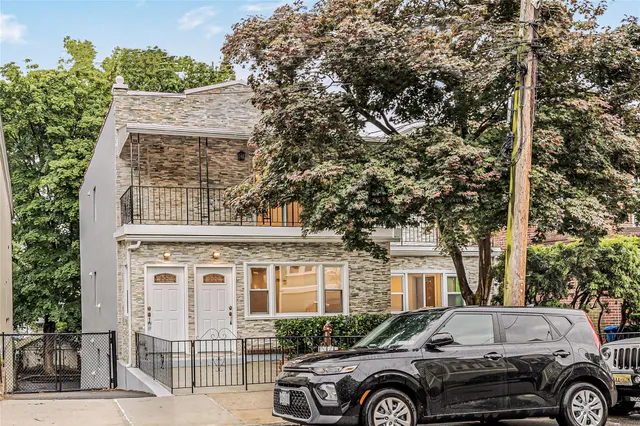 a front view of a house with parking space