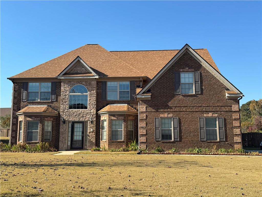a front view of a house with a yard