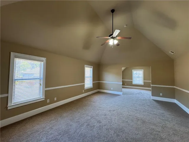 a view of a livingroom with a ceiling fan and window