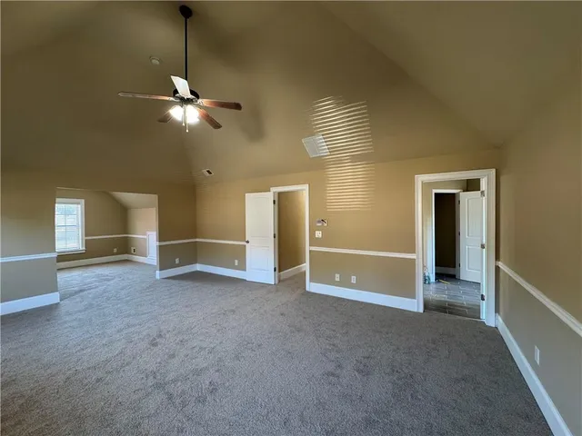 an empty room with a empty space and a ceiling fan
