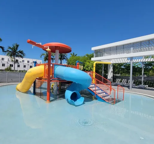 a view of a swimming pool with a patio and a yard