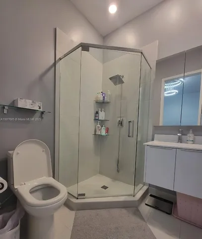 a bathroom with a toilet a sink and shower