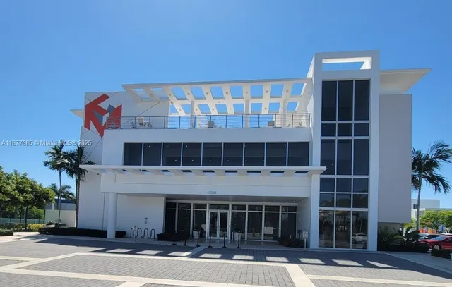 a front view of a building with a garden and plants