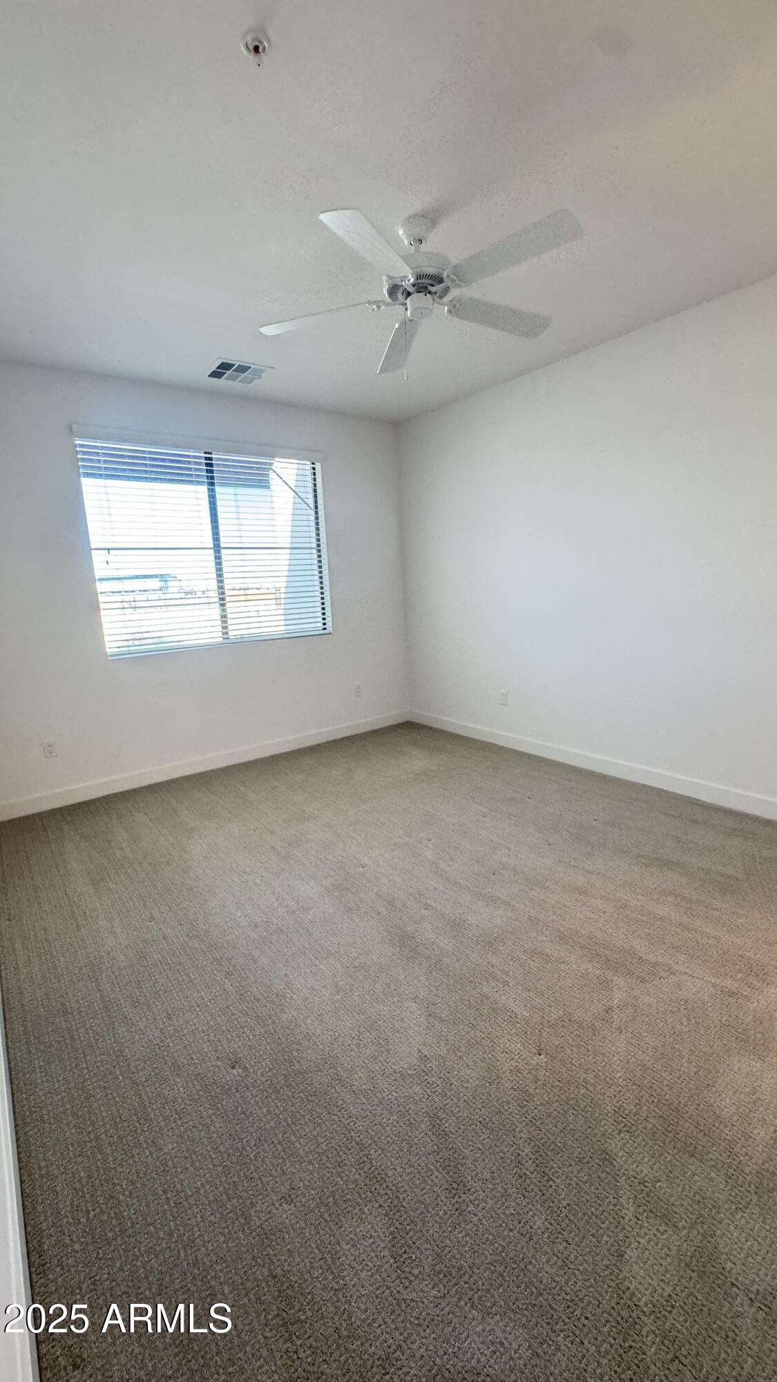 2511 West Queen Creek Road, Unit 377 Chandler, AZ 85248 - Photo 14 of 47 an empty room with a window