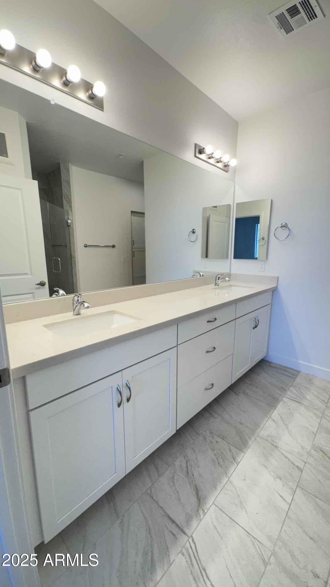 2511 West Queen Creek Road, Unit 377 Chandler, AZ 85248 - Photo 15 of 47 a spacious bathroom with a double vanity sink and a mirror