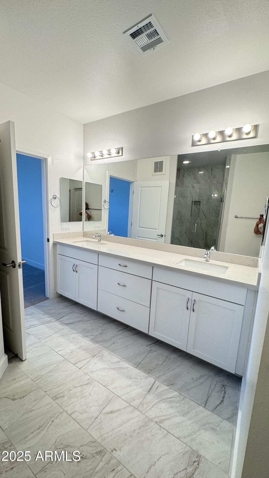 2511 West Queen Creek Road, Unit 377 Chandler, AZ 85248 - Photo 16 of 47 a spacious bathroom with a double vanity sink and mirror