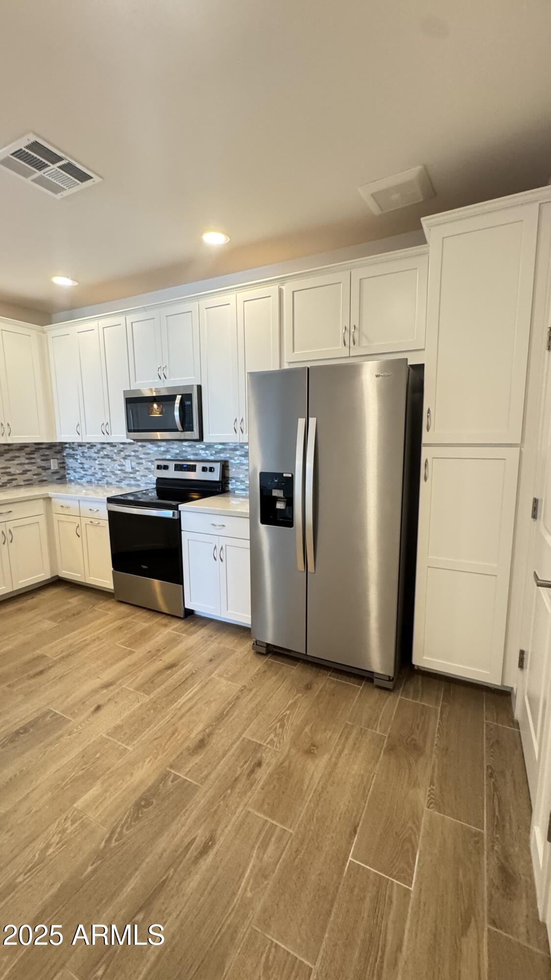 2511 West Queen Creek Road, Unit 377 Chandler, AZ 85248 - Photo 5 of 47 a kitchen with stainless steel appliances a refrigerator sink and microwave