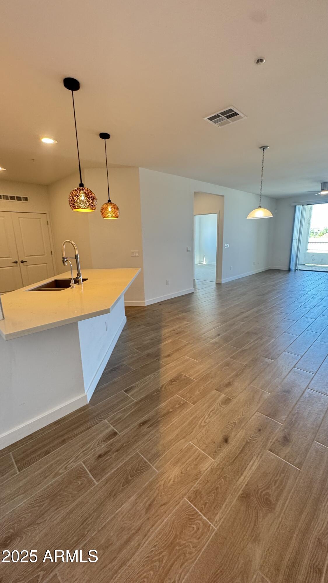 2511 West Queen Creek Road, Unit 377 Chandler, AZ 85248 - Photo 7 of 47 a view of a kitchen with a sink and wooden floor