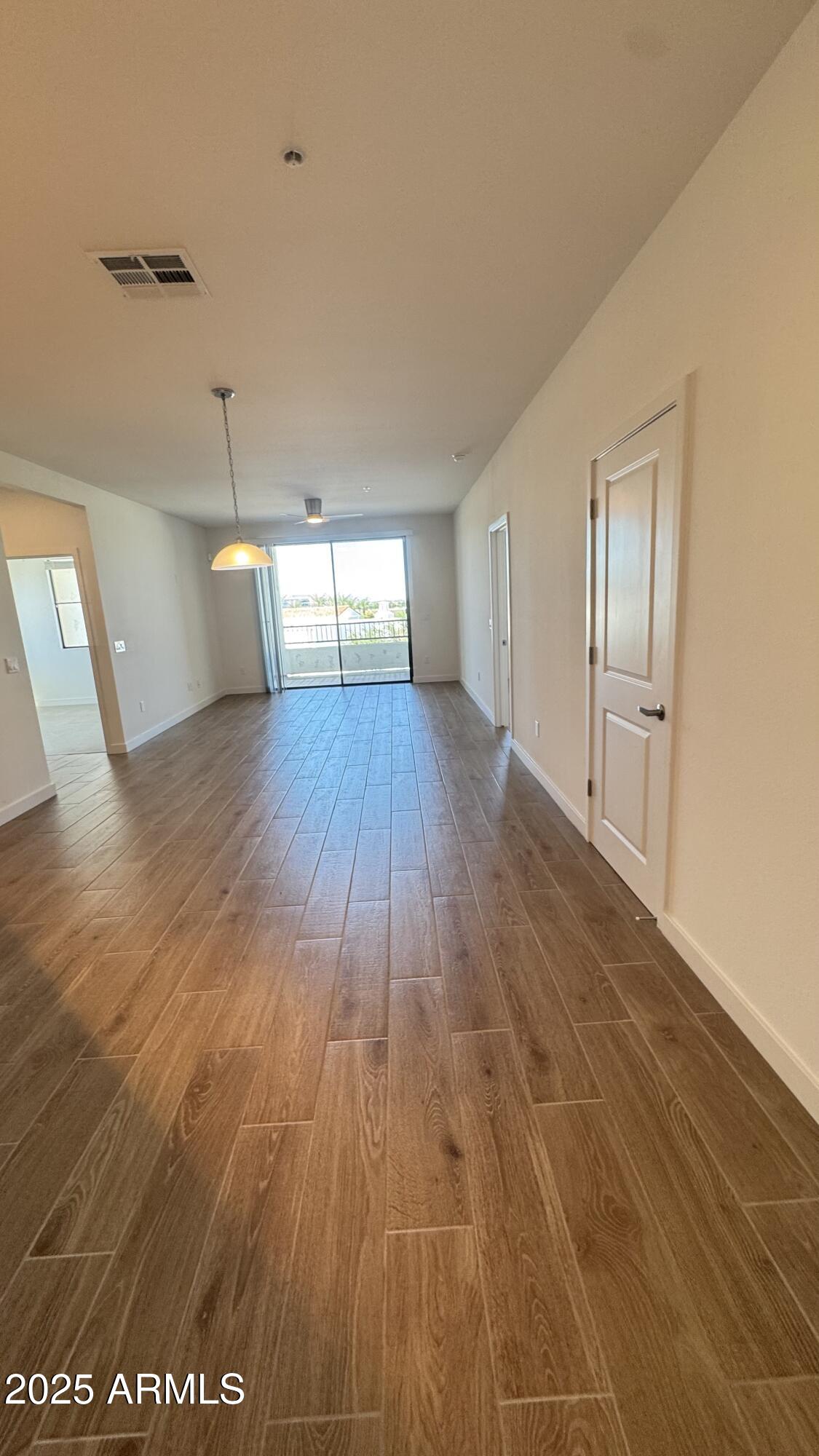2511 West Queen Creek Road, Unit 377 Chandler, AZ 85248 - Photo 10 of 47 a view of empty room with wooden floor
