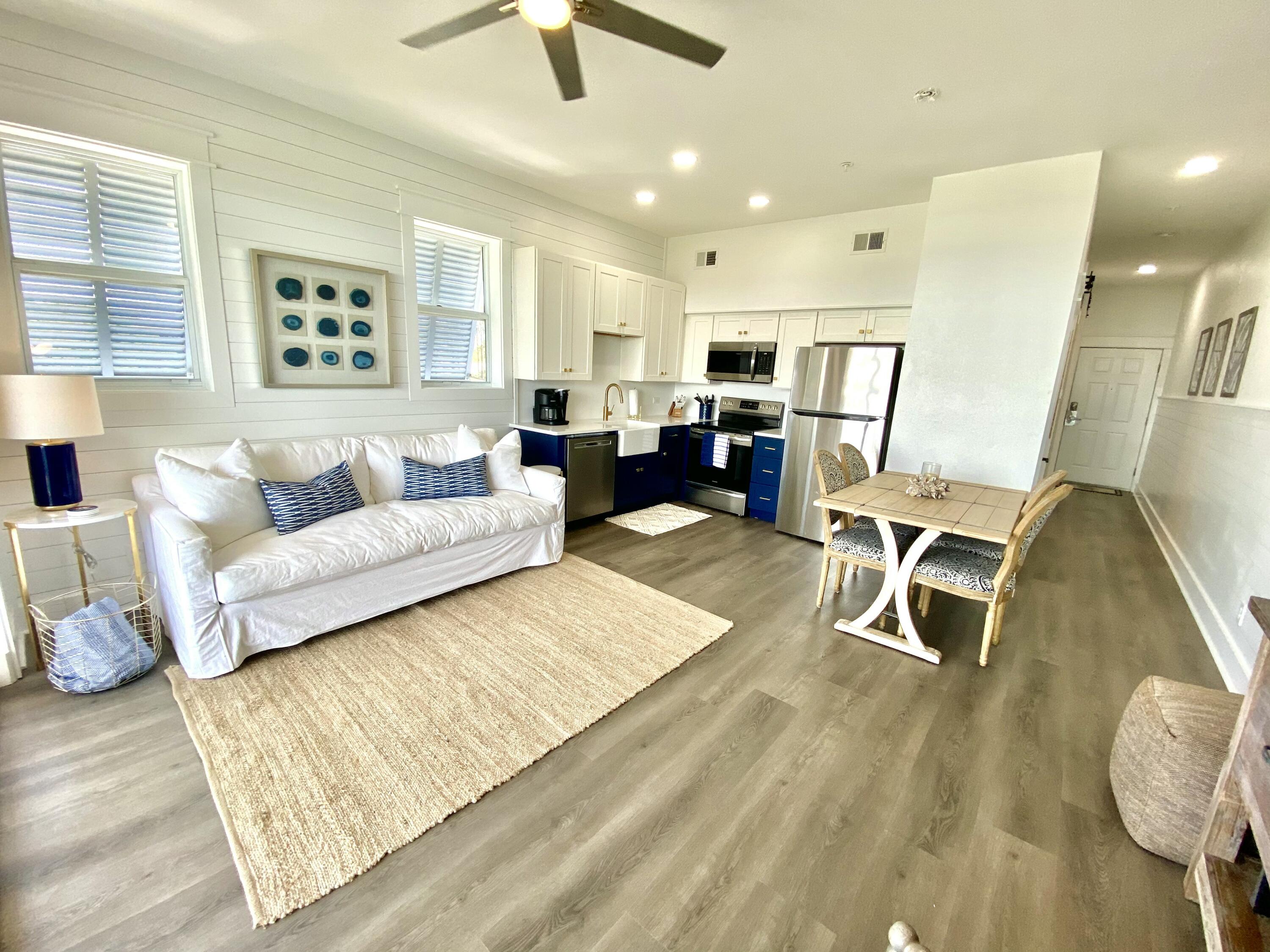 145 Spires Lane, Unit 411 Santa Rosa Beach, FL 32459 - Photo 12 of 44 a living room with furniture and a wooden floor