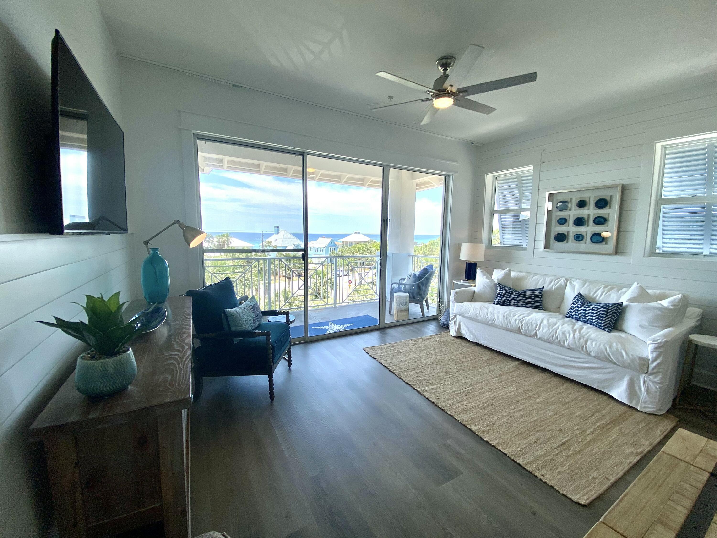 145 Spires Lane, Unit 411 Santa Rosa Beach, FL 32459 - Photo 14 of 44 a living room with furniture and a large window with wooden floor