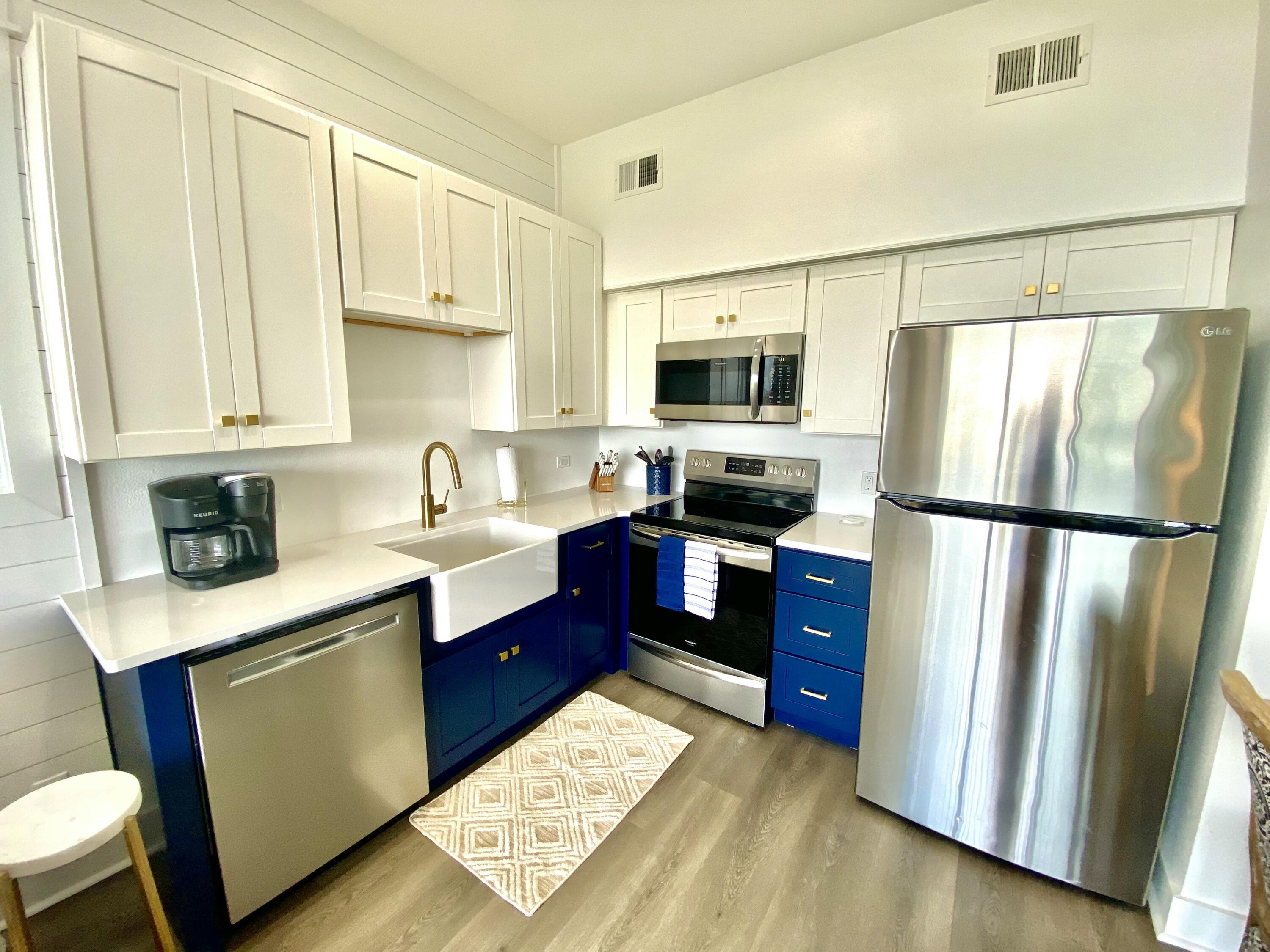 145 Spires Lane, Unit 411 Santa Rosa Beach, FL 32459 - Photo 17 of 44 a kitchen with stainless steel appliances granite countertop a refrigerator stove microwave and sink
