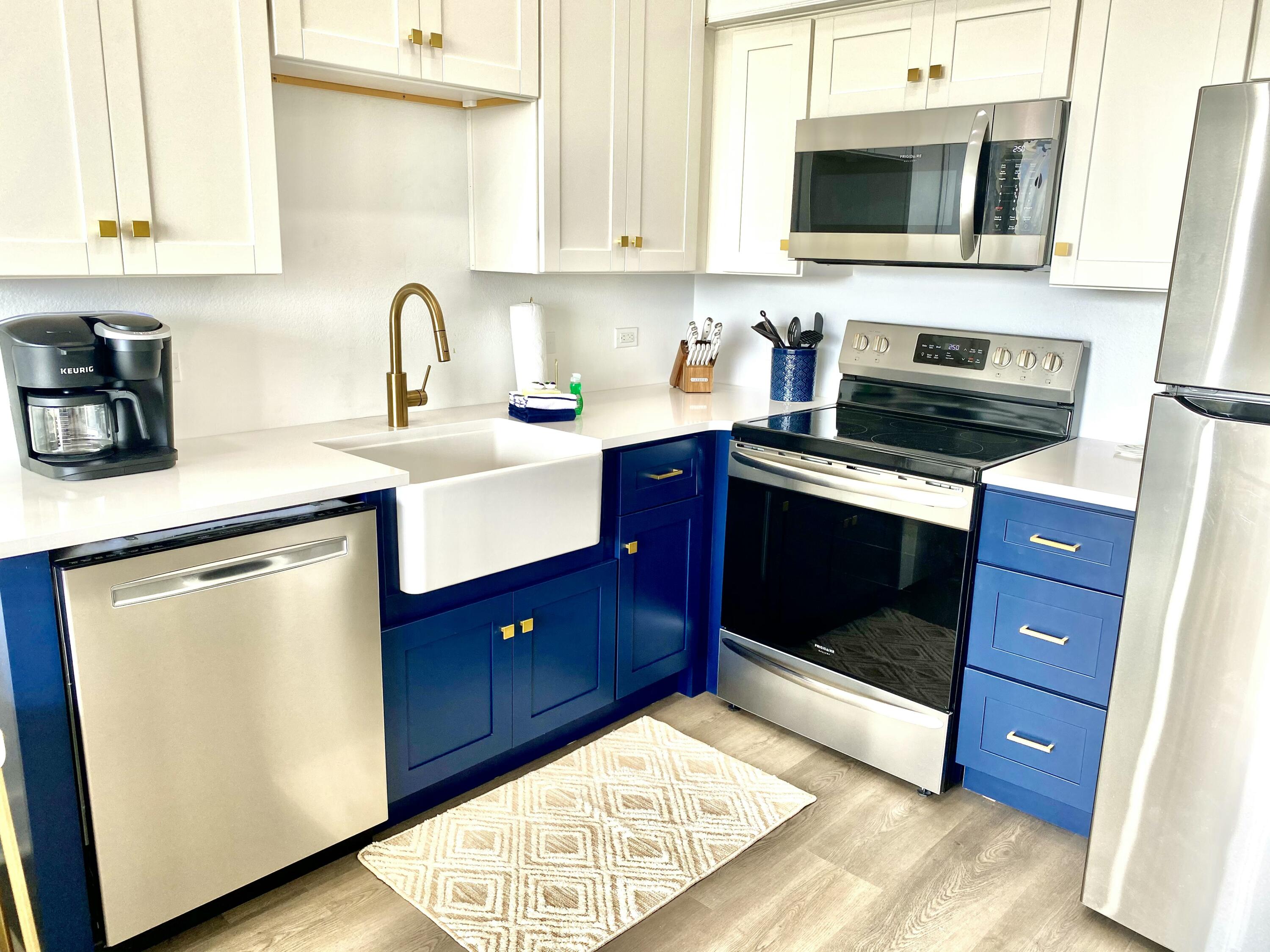 145 Spires Lane, Unit 411 Santa Rosa Beach, FL 32459 - Photo 18 of 44 a kitchen with stainless steel appliances granite countertop a stove a sink and a microwave