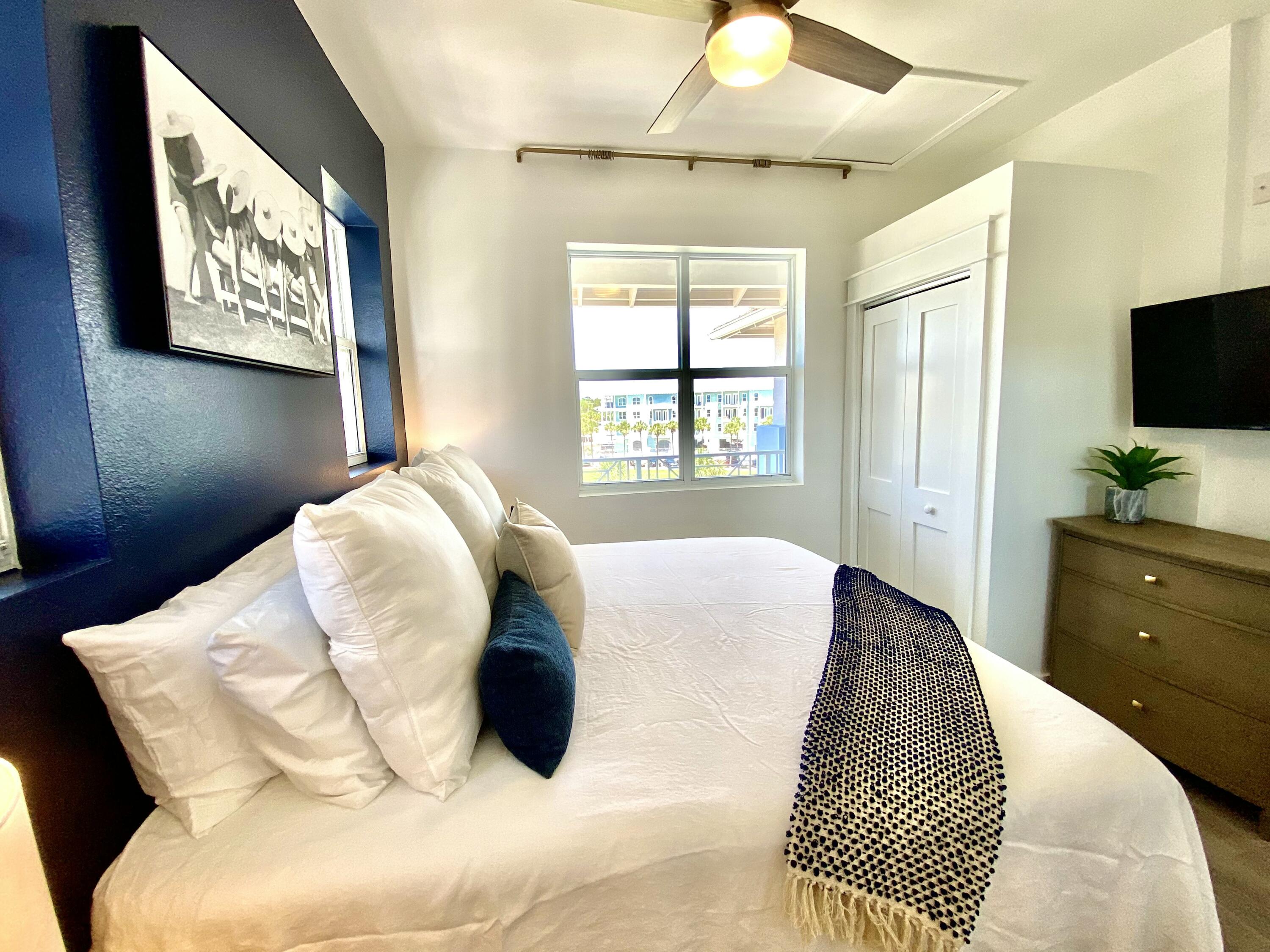 145 Spires Lane, Unit 411 Santa Rosa Beach, FL 32459 - Photo 22 of 44 a bed sitting in a bedroom next to a window