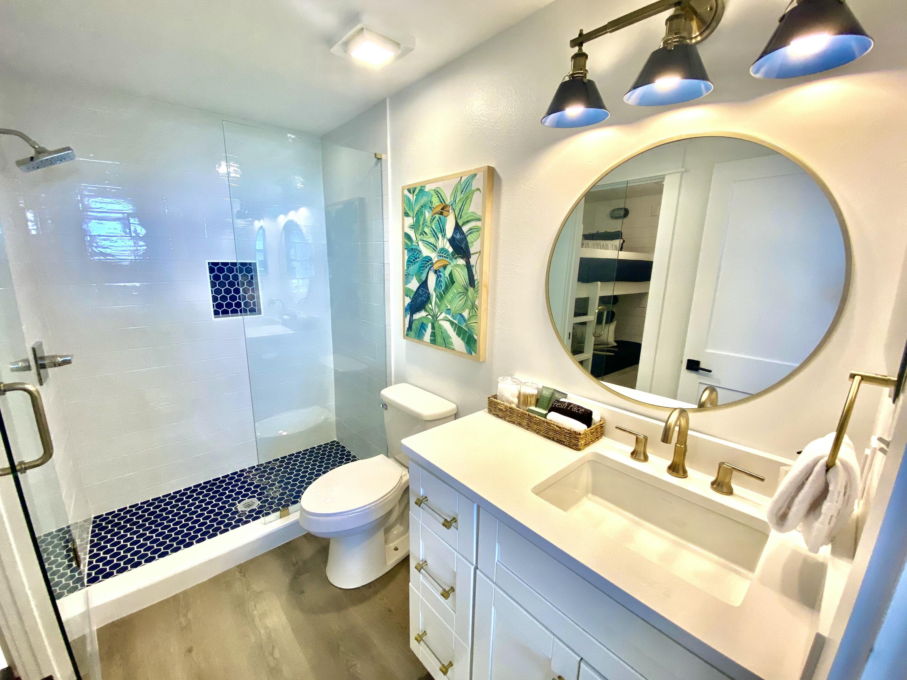 145 Spires Lane, Unit 411 Santa Rosa Beach, FL 32459 - Photo 24 of 44 a bathroom with a sink a toilet and a mirror