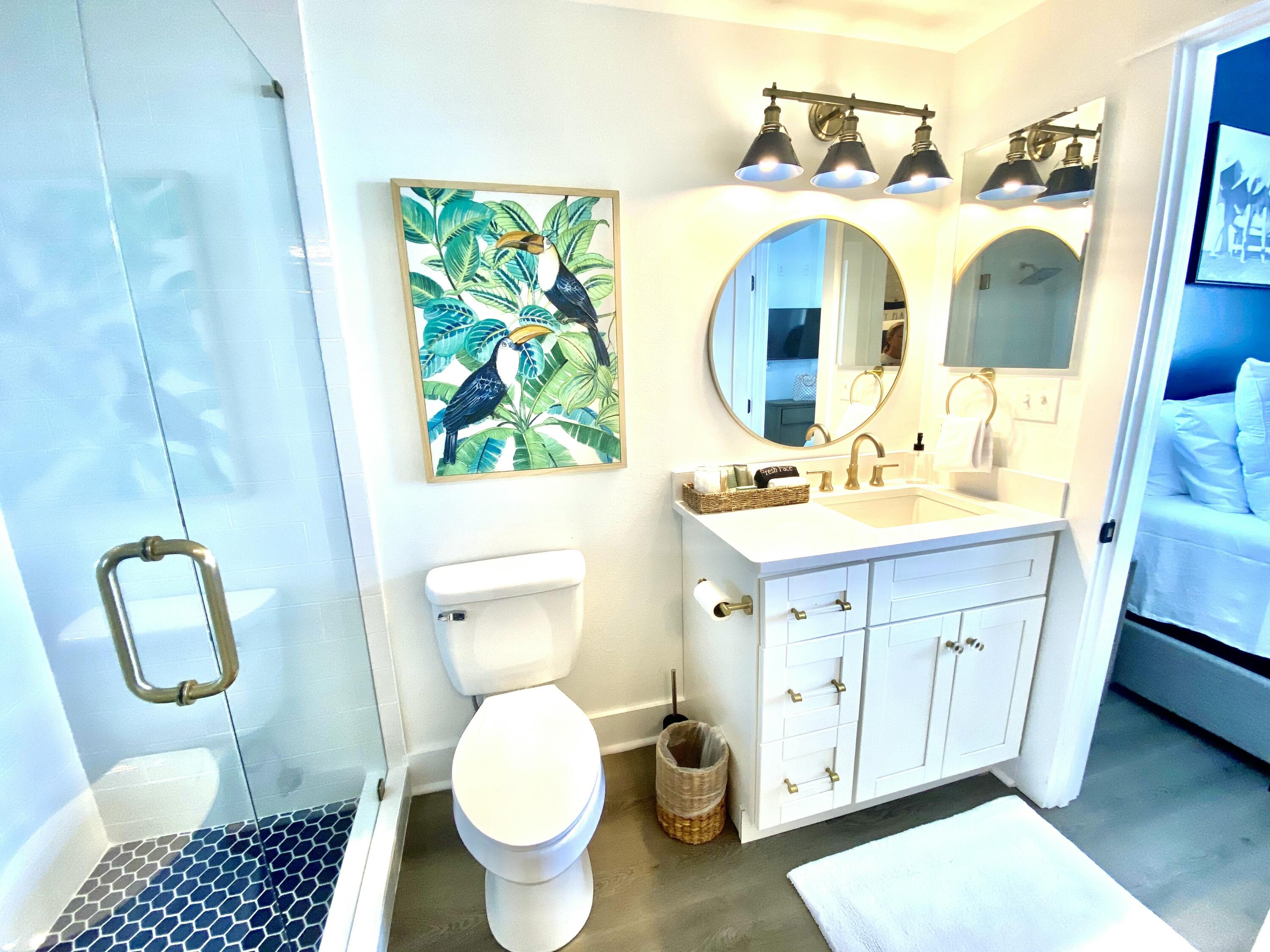 145 Spires Lane, Unit 411 Santa Rosa Beach, FL 32459 - Photo 27 of 44 a bathroom with a toilet sink vanity and mirror