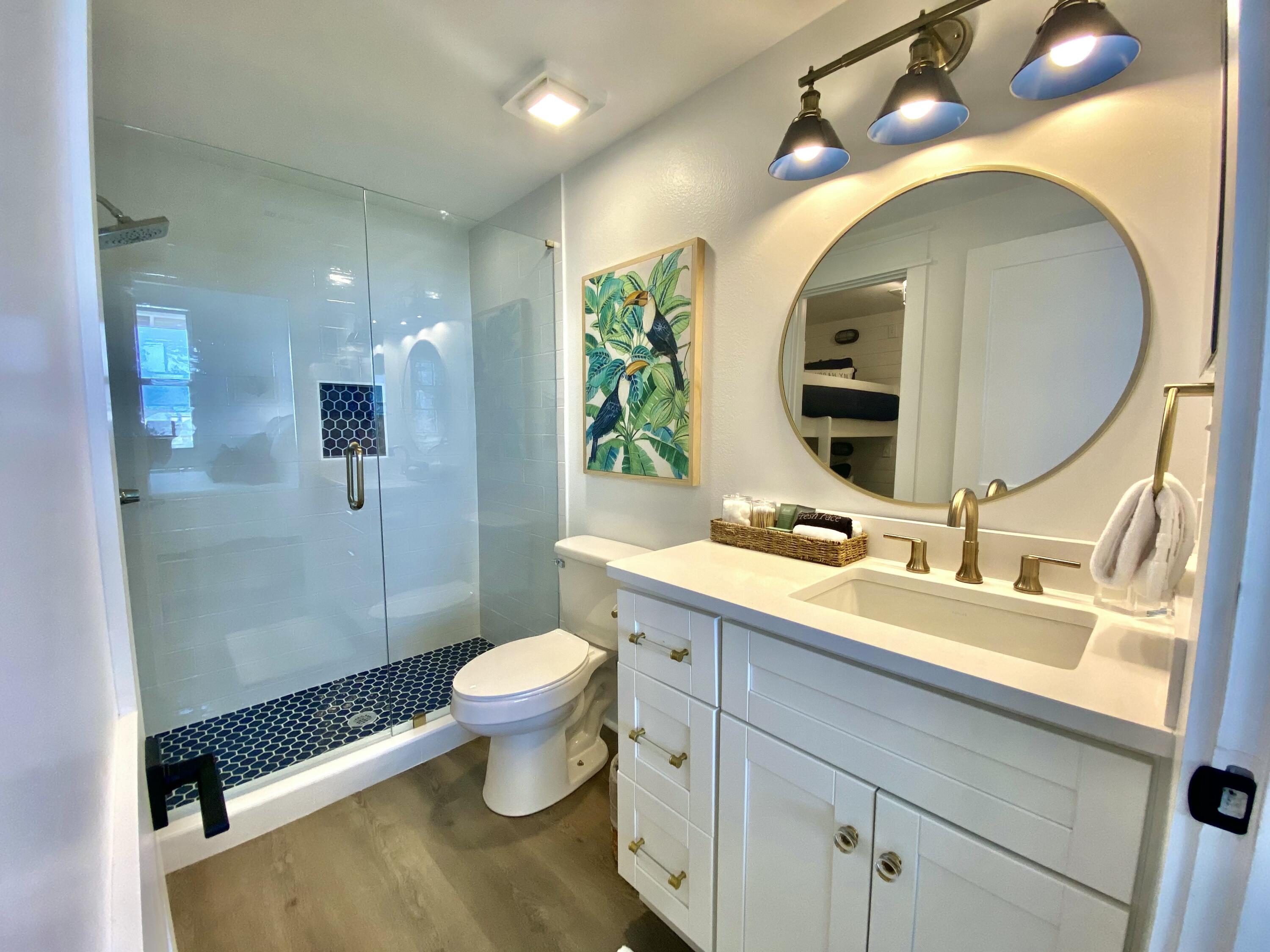 145 Spires Lane, Unit 411 Santa Rosa Beach, FL 32459 - Photo 30 of 44 a bathroom with a granite countertop toilet sink and mirror