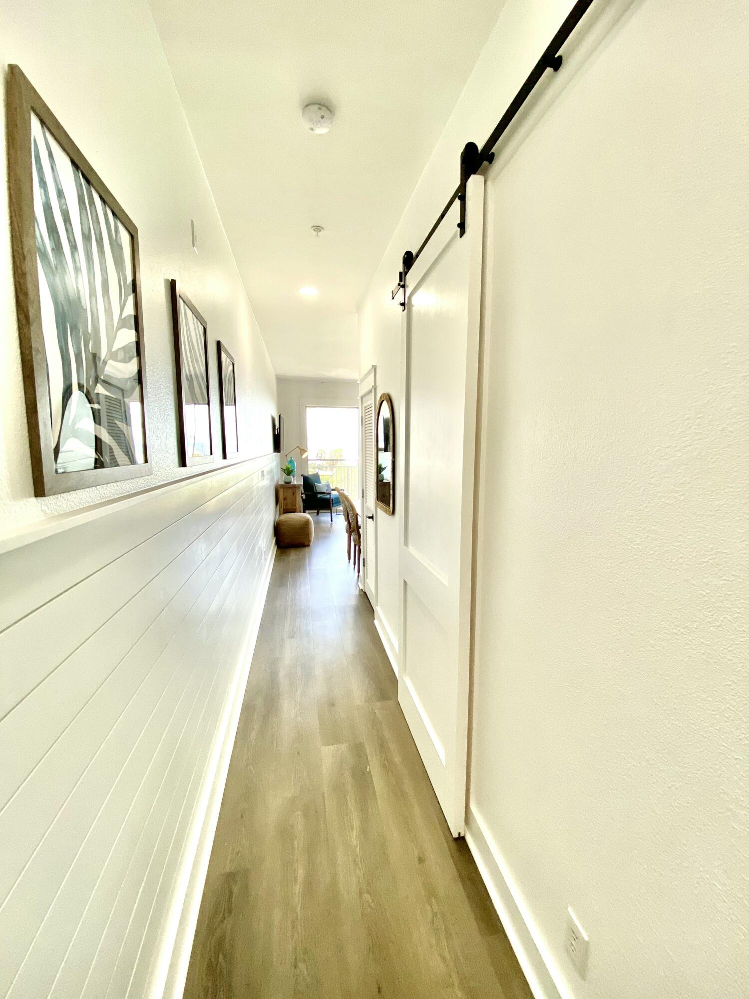 145 Spires Lane, Unit 411 Santa Rosa Beach, FL 32459 - Photo 32 of 44 a view of a hallway with wooden floor