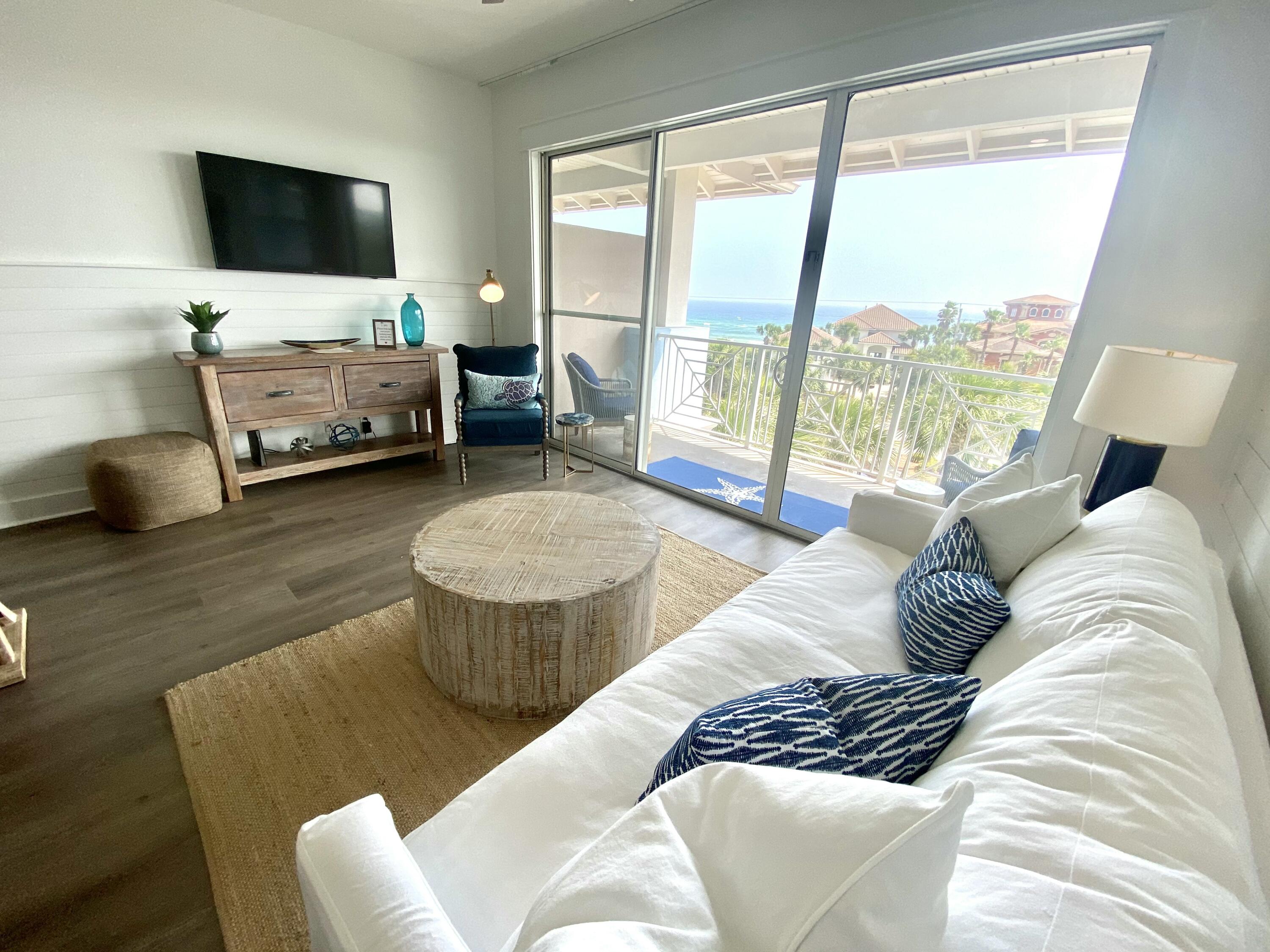 145 Spires Lane, Unit 411 Santa Rosa Beach, FL 32459 - Photo 10 of 44 a living room with furniture and a flat screen tv