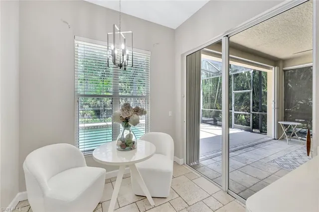 a dining room with furniture and a floor to ceiling window