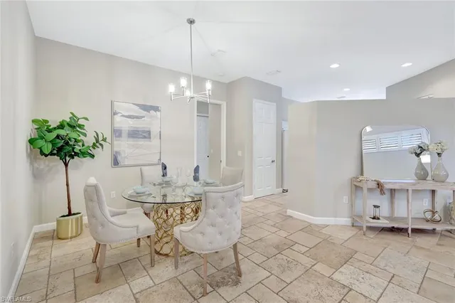 a view of a dining room with furniture and chandelier