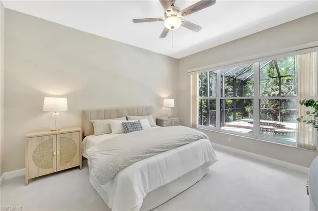 a bedroom with a large bed and a large window