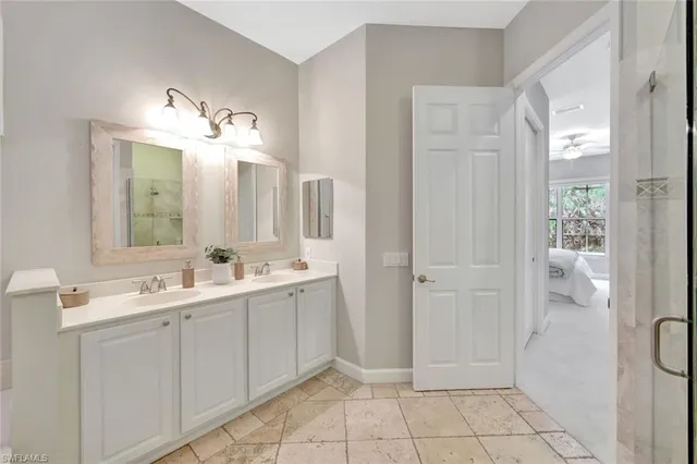a bathroom with a double vanity sink mirror and
