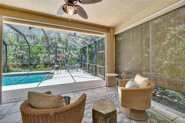a living room with couch and a floor to ceiling window