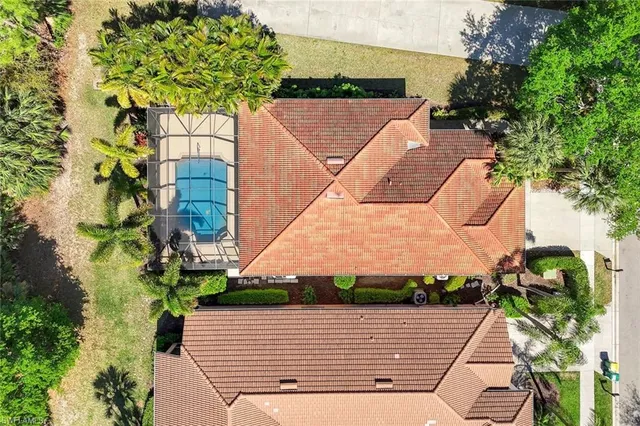an aerial view of a house with a yard and furniture