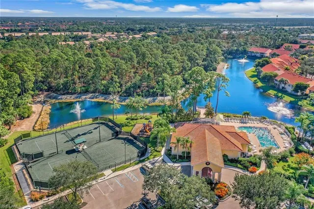 an aerial view of a house with a yard and lake view