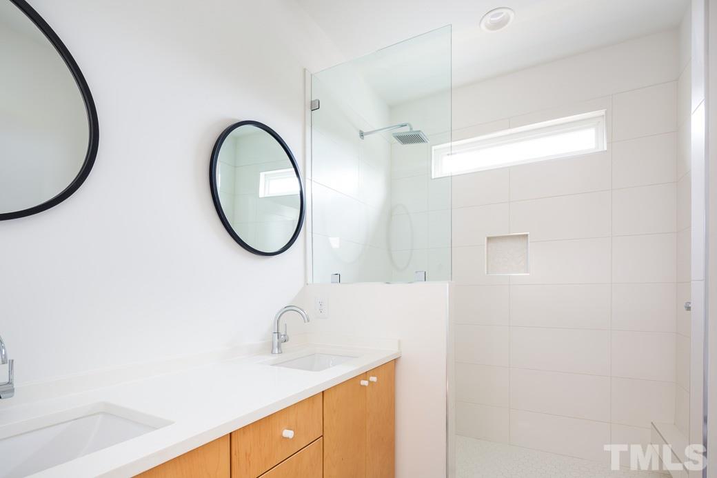 617 New Bern Avenue Raleigh, NC 27601 - Photo 11 of 16 a bathroom with a sink and a mirror