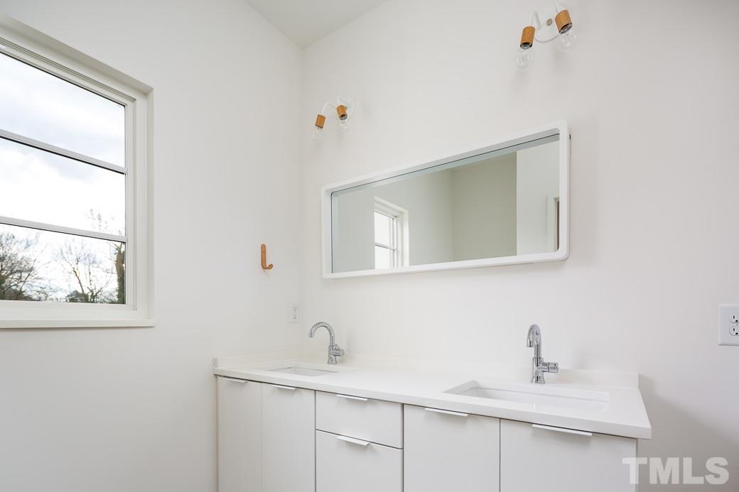 617 New Bern Avenue Raleigh, NC 27601 - Photo 14 of 16 a bathroom with a sink and a mirror