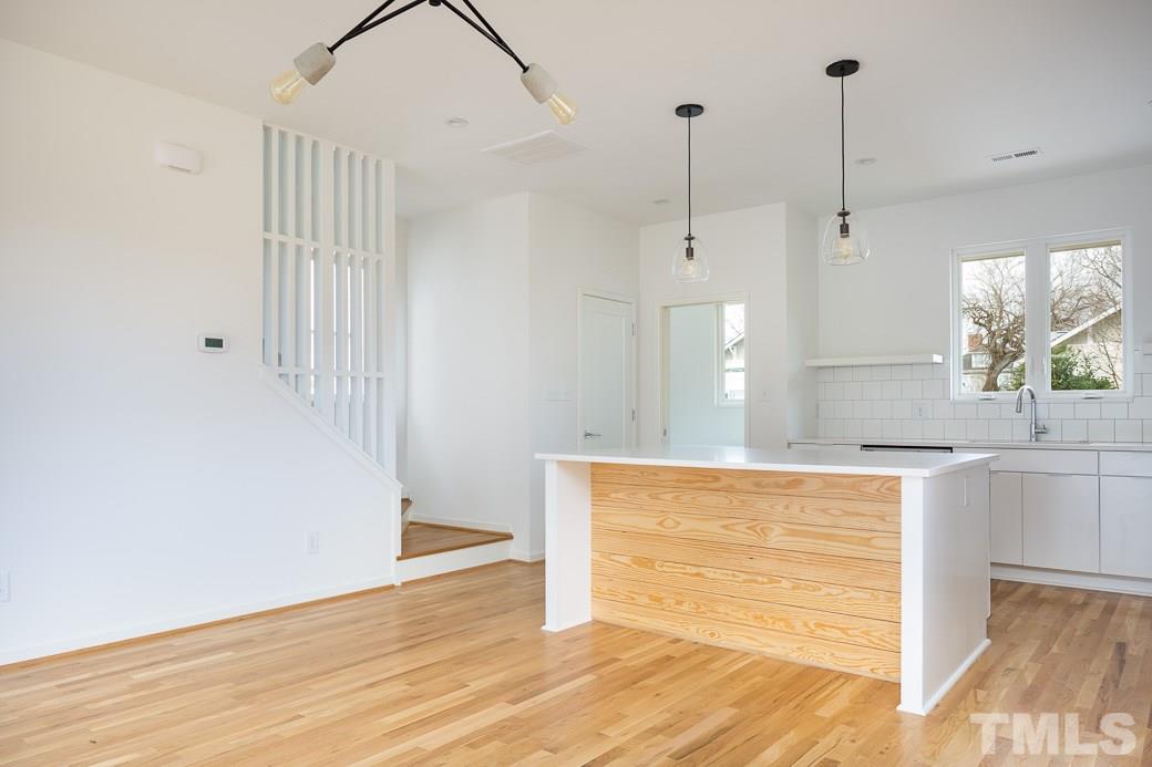 617 New Bern Avenue Raleigh, NC 27601 - Photo 3 of 16 a view of a kitchen with wooden floor and a sink