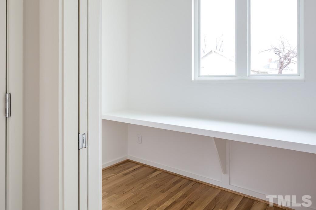 617 New Bern Avenue Raleigh, NC 27601 - Photo 6 of 16 an empty room with wooden floor and windows