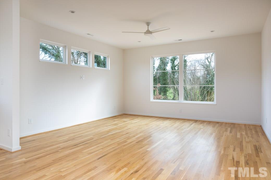 617 New Bern Avenue Raleigh, NC 27601 - Photo 7 of 16 a view of an empty room with wooden floor and a window