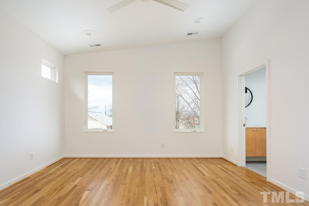 617 New Bern Avenue Raleigh, NC 27601 - Photo 10 of 16 a view of an empty room with a window and wooden floor