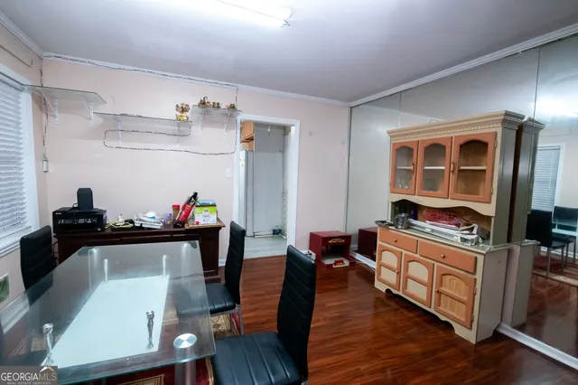 a kitchen with granite countertop a stove and wooden floor