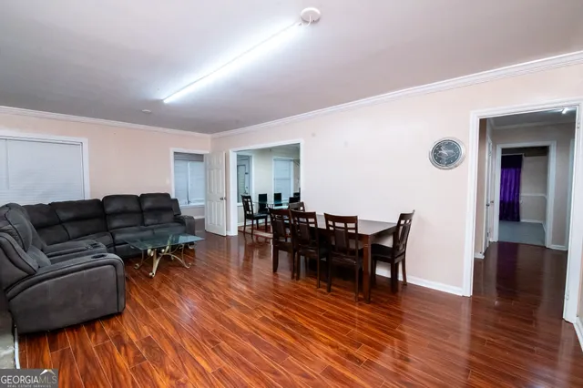 a living room with furniture and wooden floor