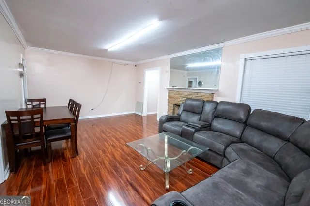 a living room with furniture and wooden floor
