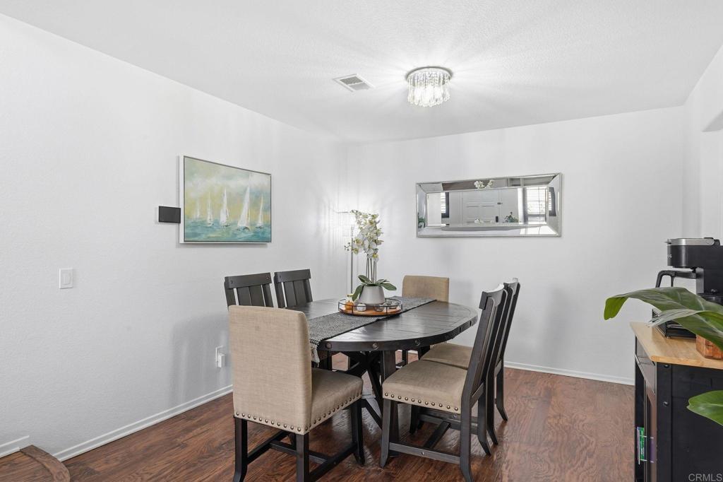 2505 Whispering Palms Loop Chula Vista, CA 91915 - Photo 15 of 45 a dining room with furniture and wooden floor