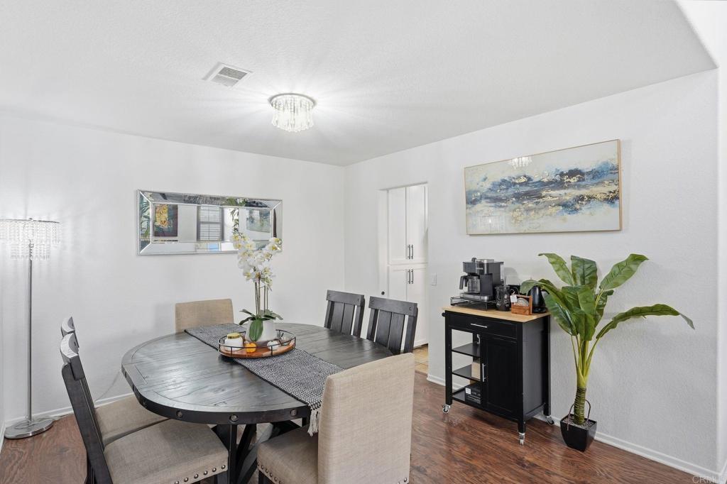 2505 Whispering Palms Loop Chula Vista, CA 91915 - Photo 16 of 45 a view of a dining room with furniture and wooden floor