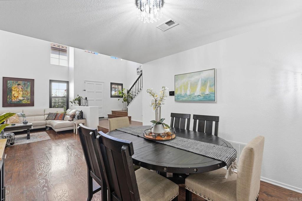 2505 Whispering Palms Loop Chula Vista, CA 91915 - Photo 17 of 45 a view of a dining room with furniture and a potted plant
