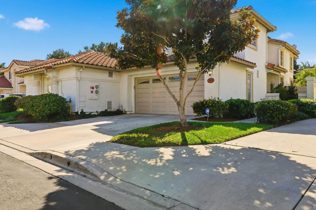 2505 Whispering Palms Loop Chula Vista, CA 91915 - Photo 2 of 45 a front view of a house with a yard and garage