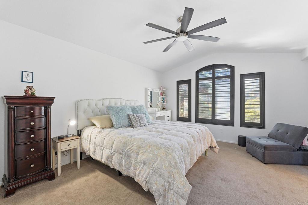 2505 Whispering Palms Loop Chula Vista, CA 91915 - Photo 21 of 45 a bedroom with a bed a couch and a window