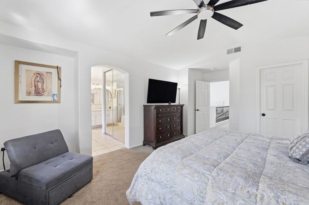 2505 Whispering Palms Loop Chula Vista, CA 91915 - Photo 22 of 45 a spacious bedroom with a bed and a flat screen tv