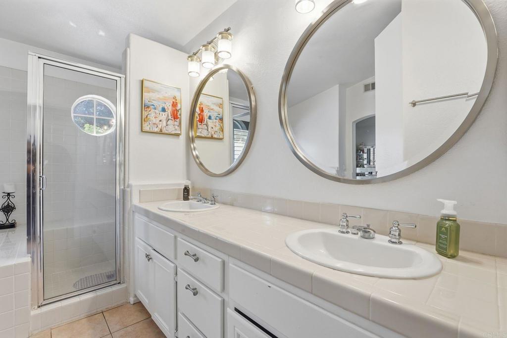 2505 Whispering Palms Loop Chula Vista, CA 91915 - Photo 23 of 45 a bathroom with a sink and a mirror