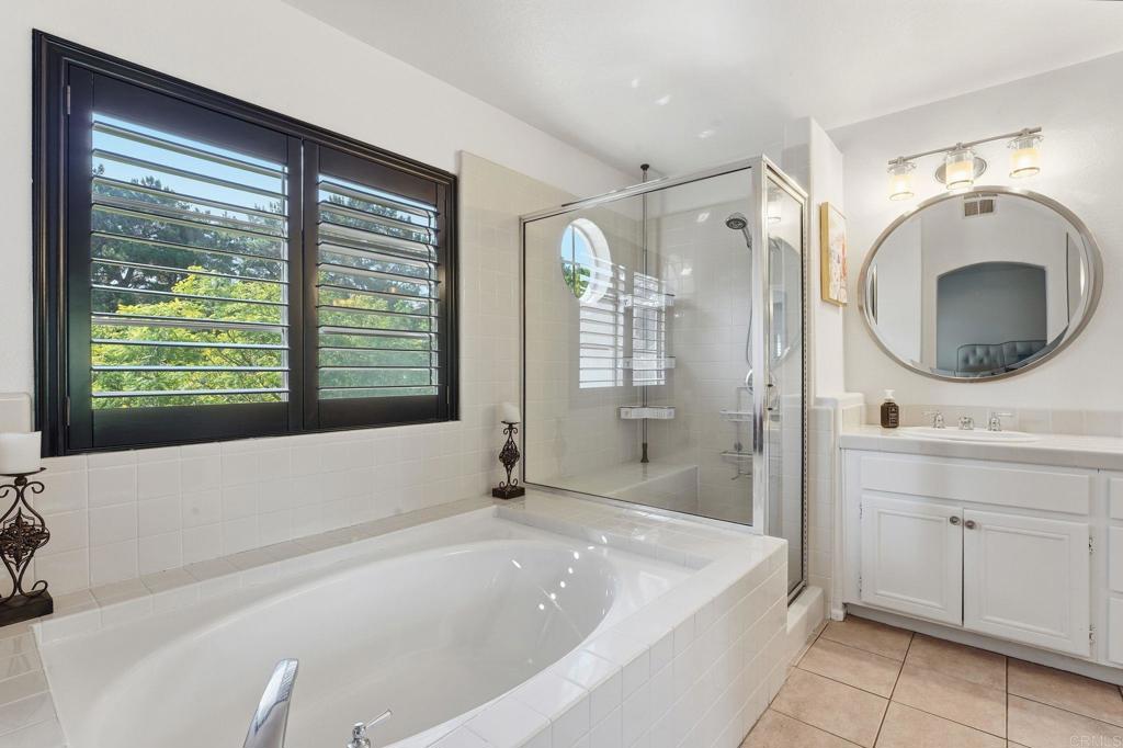 2505 Whispering Palms Loop Chula Vista, CA 91915 - Photo 24 of 45 a bathroom with a tub sink and mirror