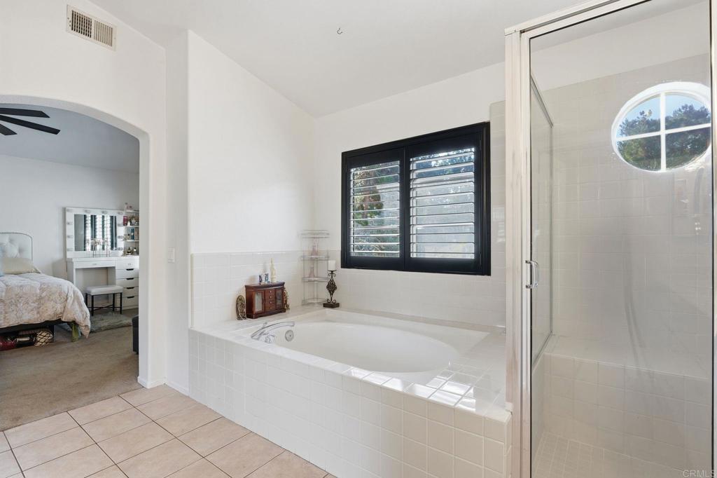 2505 Whispering Palms Loop Chula Vista, CA 91915 - Photo 25 of 45 a bathroom with a tub sink and mirror