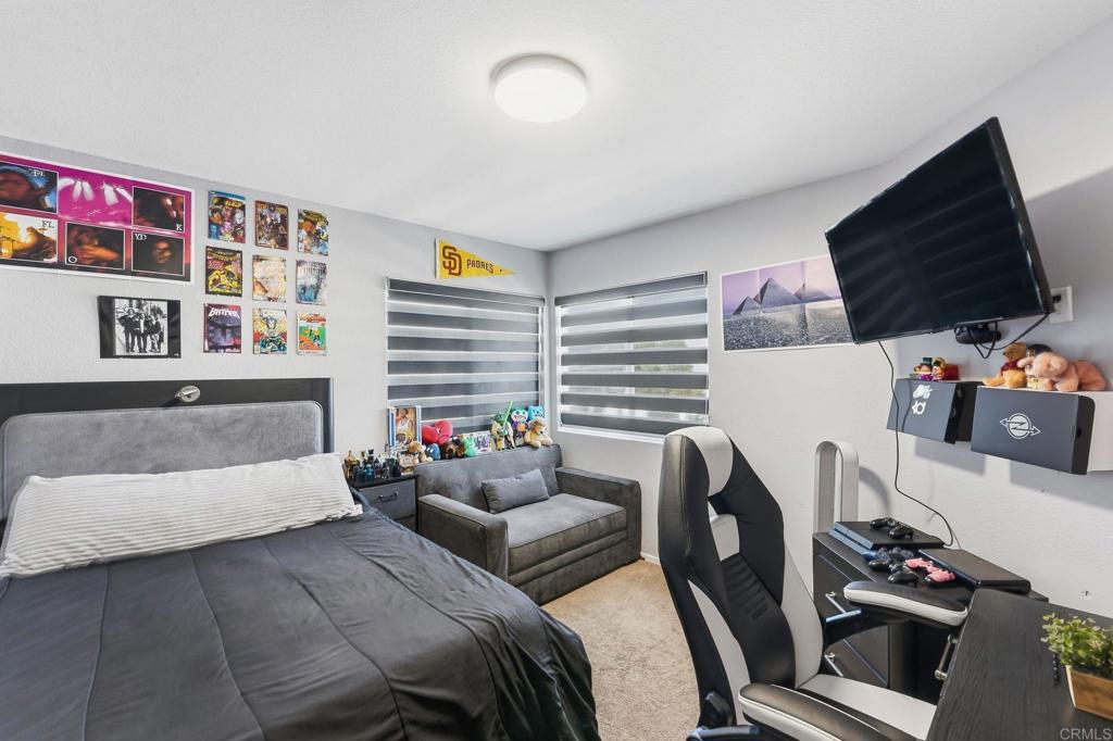 2505 Whispering Palms Loop Chula Vista, CA 91915 - Photo 26 of 45 a bedroom with furniture and a flat screen tv